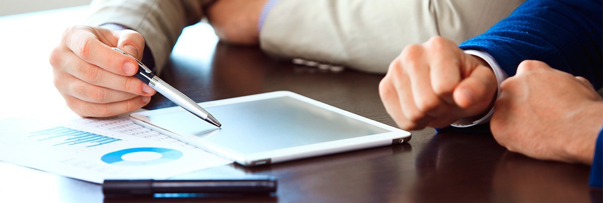People looking down at tablet, reviewing home regulation changes