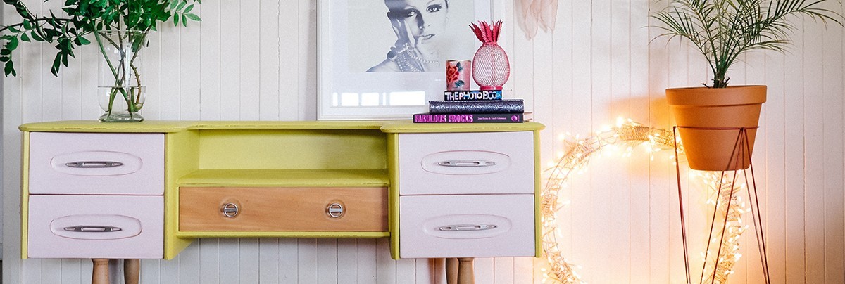 Chest of drawers revamped with pastel purple drawers and yellow green body using Chalk Paint.