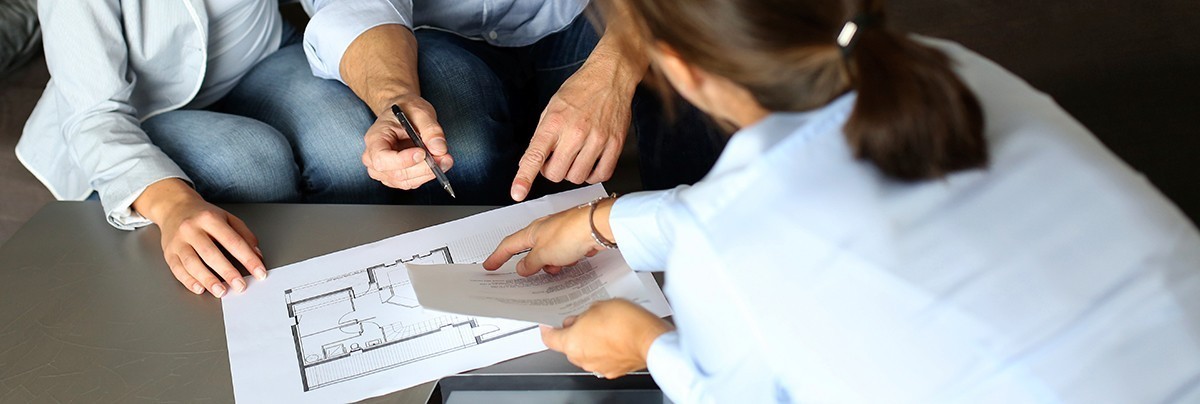 Couple looking over detailed home renovation plan.