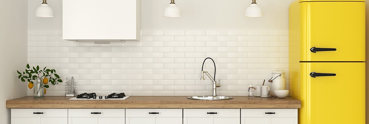 Kitchen with bright yellow fridge and tiles decoration