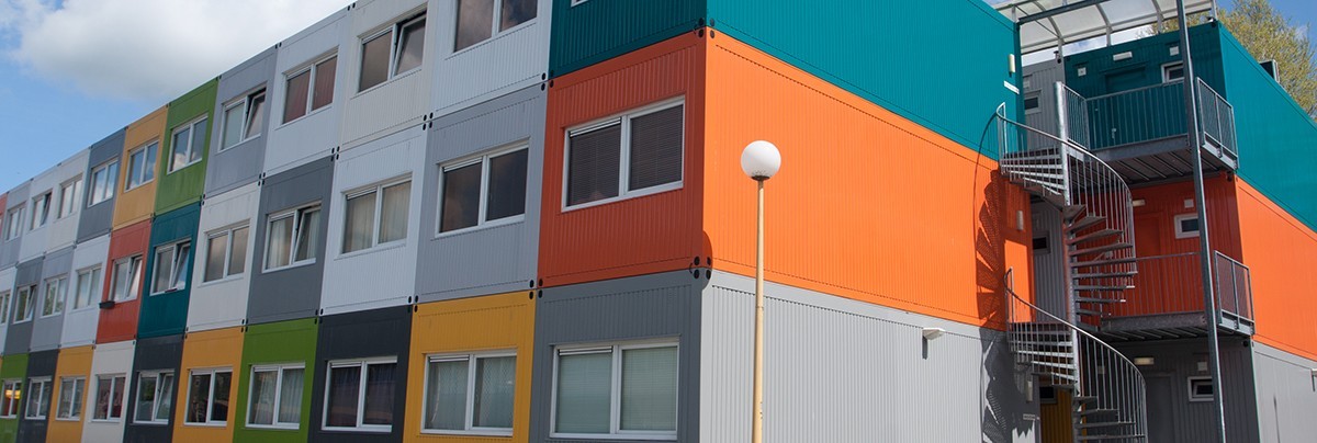 Colored shipping containers stacked to create living block