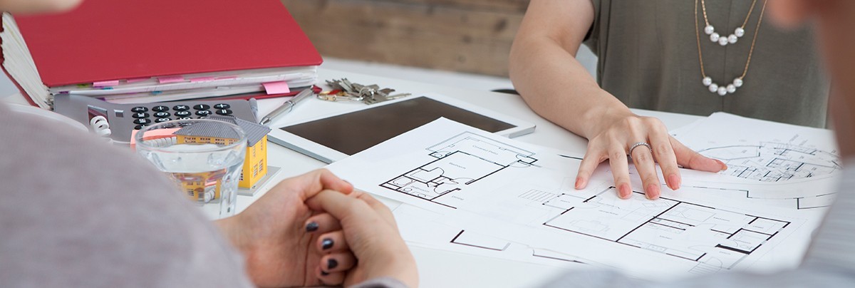 Expert helping couple with their building plans