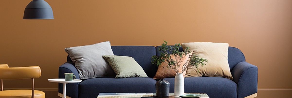 a living room with orange painting wall