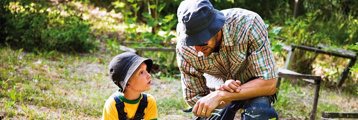 A picture of father and son in green background
