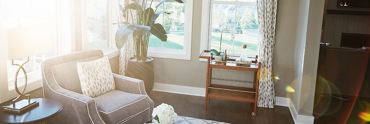 A living room with lots of sunlight and large windows