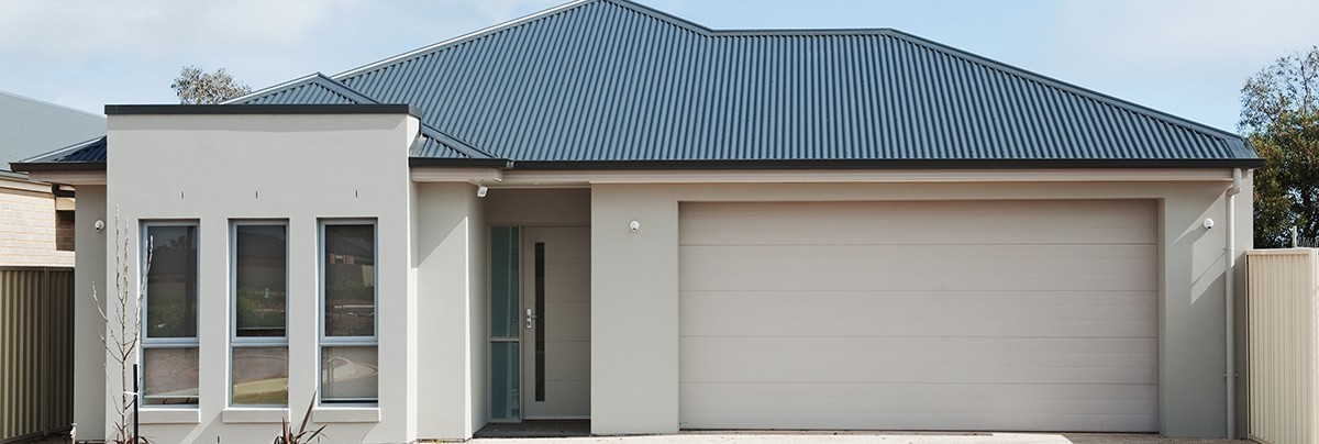 A house with blue roof and off-white paint