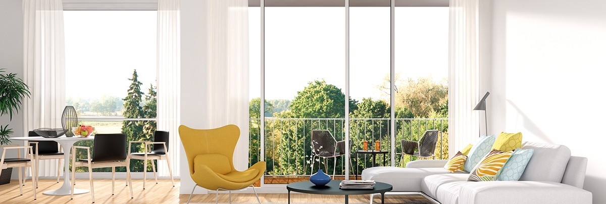 A living room with yellow chair and glass window