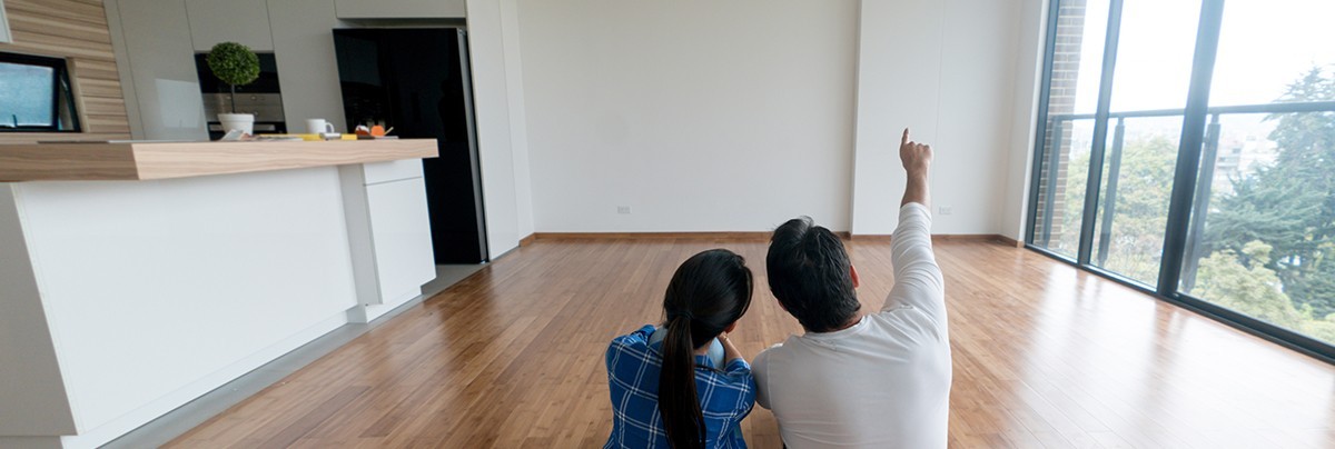 couple sit in empty apartment