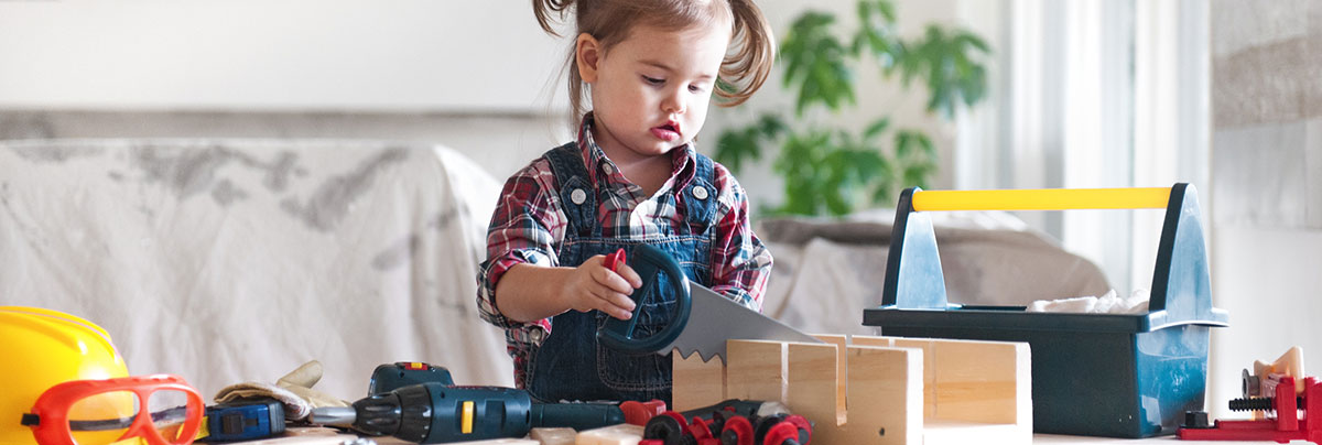 toddler playing with tools
