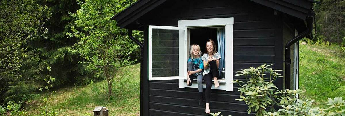 A small black house with two happy kids