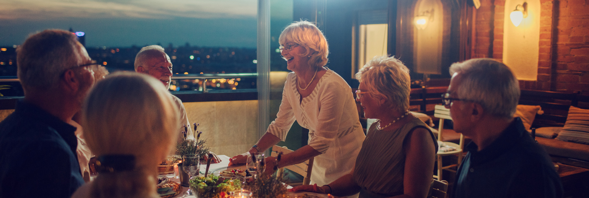Friends dining on roof terrace