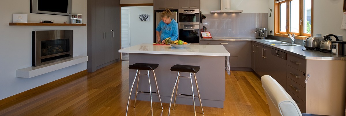 A kitchen renovation with wooden floor and new appliances.