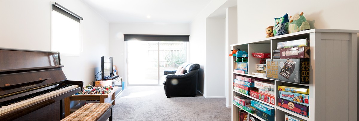 living room with a piano and new carpet