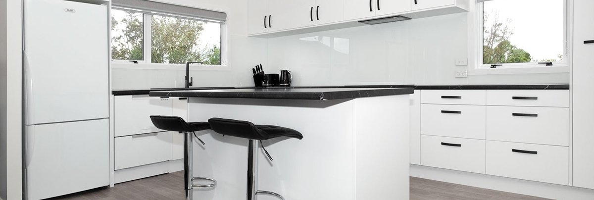 This home's kitchen, lounge, bathroom, and laundry room were renovated with a sleek, modern design that contrasts significantly from the build