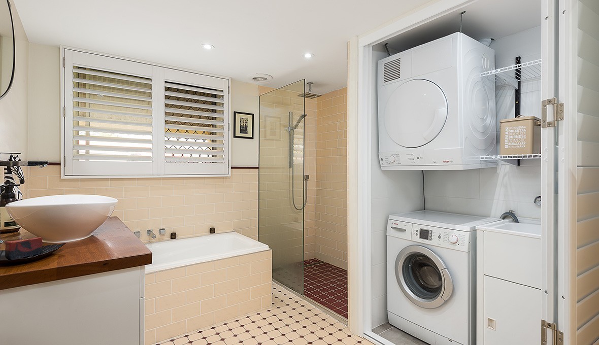 Bathroom with hidden storage for laundry