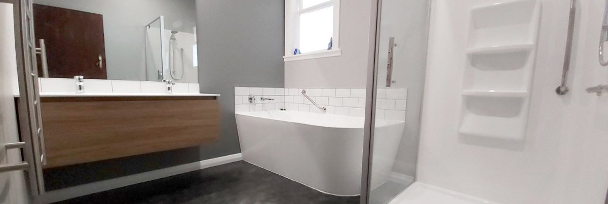 Complete bathroom update with a new shower, freestanding bathtub and wall-hung vanity.