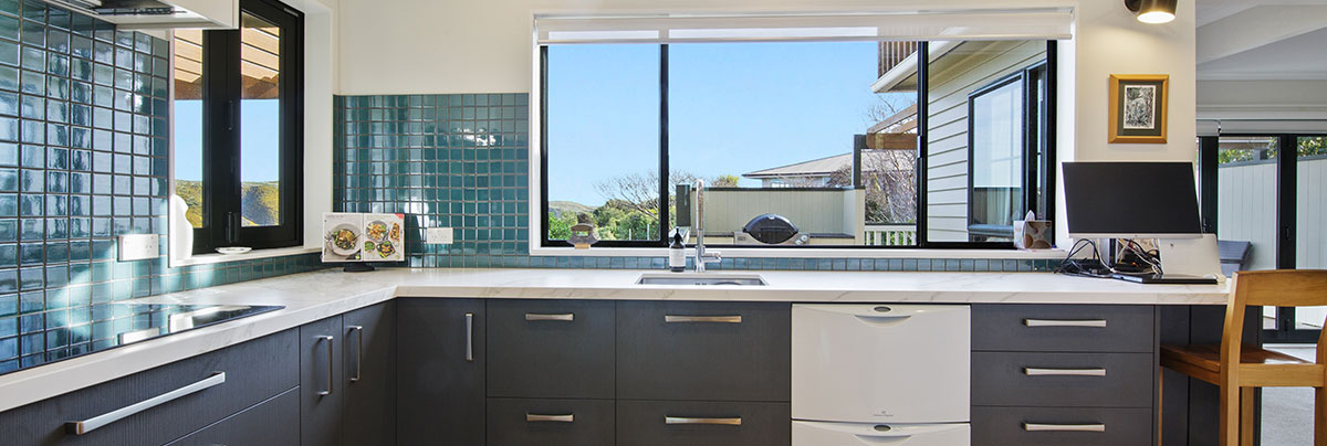 A modern, open-plan kitchen update with a new scullery, deck extension and built-in barbeque.