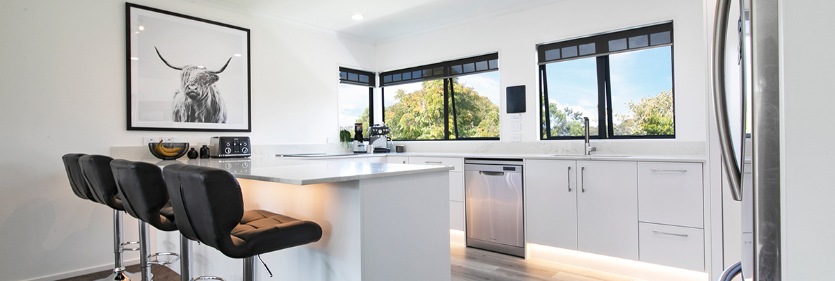 This renovation integrated minimalist design and modern fixtures to transform the kitchen into a fresh yet welcoming space.