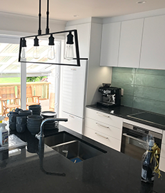 Renovated kitchen with green splashback