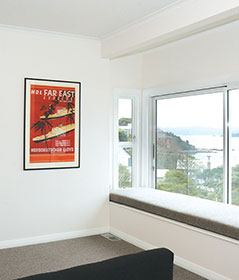 The new kitchen features white walls and furniture to contrast with the black tiling.