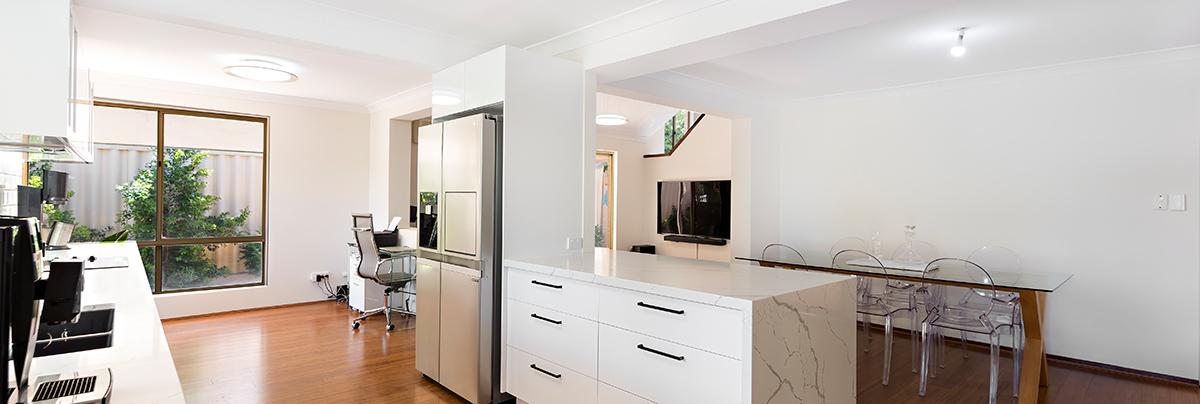 Intensive structural work was required to take the ground floor of this Maylands townhouse from dark and disjointed to bright and open.