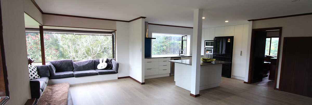 Removing walls and upgrading fixtures has transformed this home's kitchen and lounge into a large, modern living area.