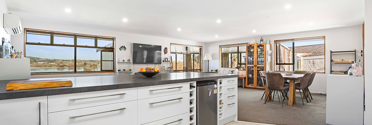 This 1980s property was renovated to modernise its dated interiors with an open-plan layout and make the most of the lakeside views.