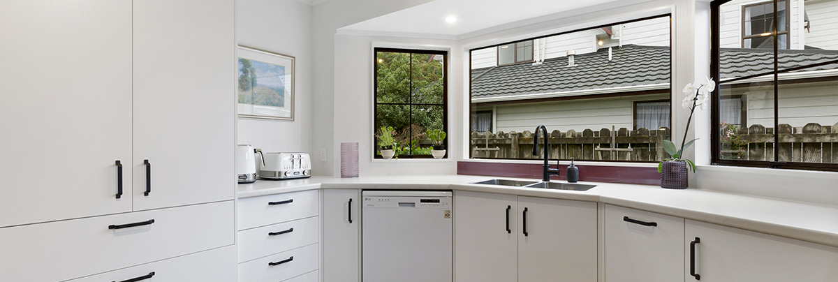 This dated 1980s kitchen received a complete makeover, transforming the room into a modern marvel.