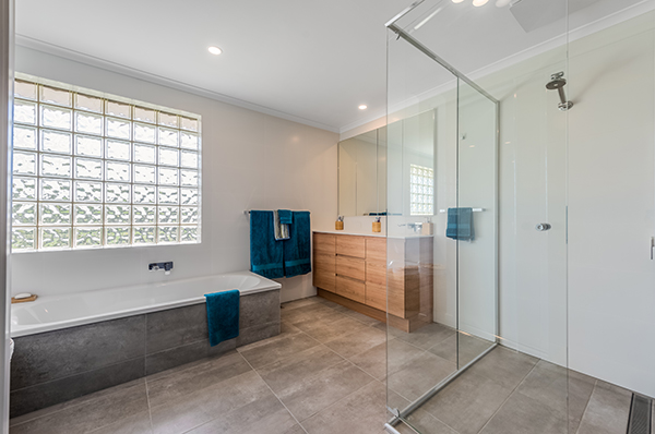 This two-storey home received two beautiful bathroom upgrades and a ground-level extension for an additional room.