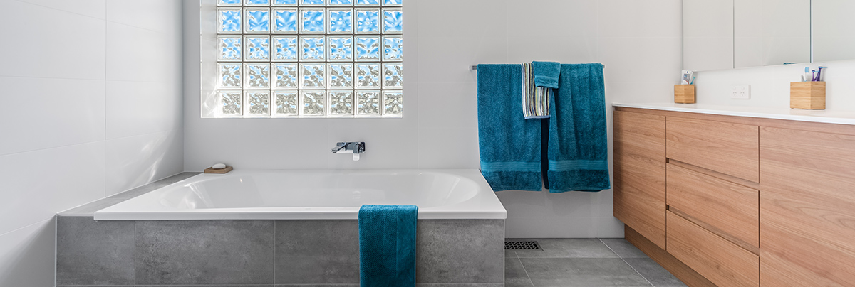 This two-storey home received two beautiful bathroom upgrades and a ground-level extension for an additional room.