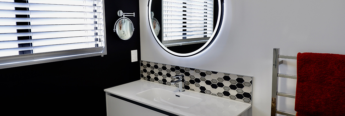 This Waihi holiday home is now perfectly suited for beachside living after a complete upgrade of its two bathrooms, water closet, and laundry.