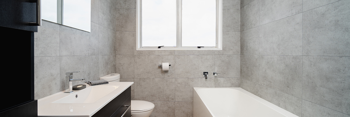 This project completely transformed two bathrooms that were stuck in the 1970s, renewing both interiors with sophisticated designs.