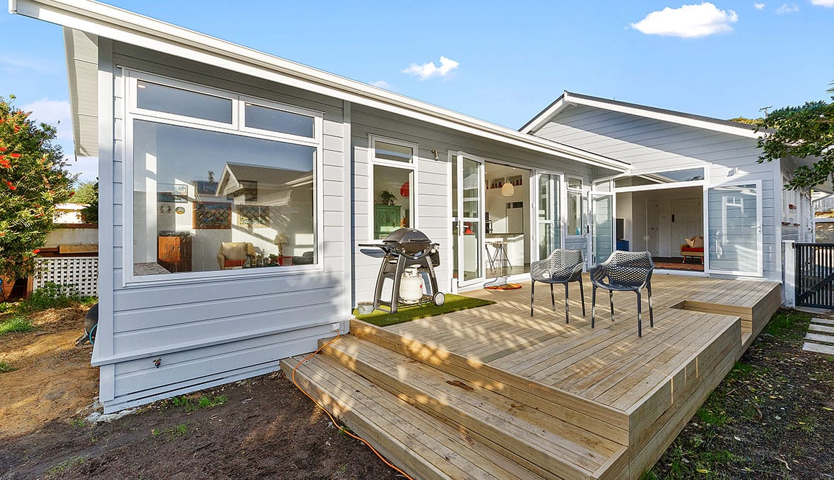 home extension with outdoor BBQ place with a deck in Nelson