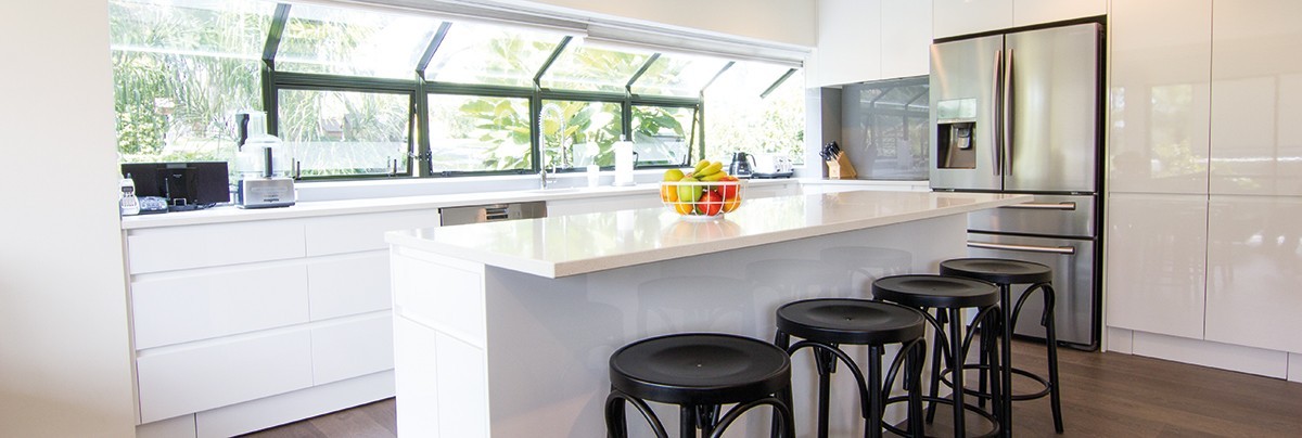 Renovated kitchen, dining area and lounge in three storey townhouse.