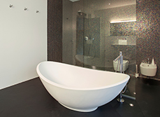 Mid-range bathroom renovation with simple taps and a bath.