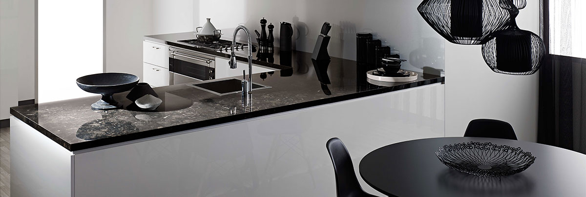 Black marble with brown specs kitchen countertop, in sharp contrast with white white cabinetry