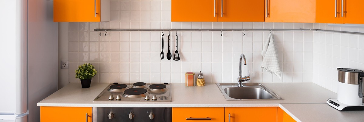 Home kitchen renovation with orange cabinet, basic appliances.