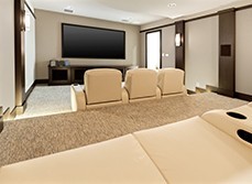 Media room with plasma tv and two rows of cinema-like seating