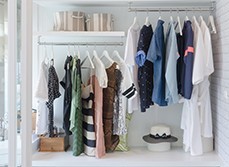 Two sideway levels of hangers in a modern but simple walk-in wardrobe