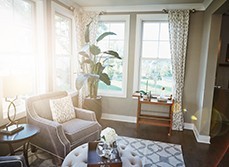 A living room with lots of sunlight and large windows