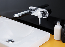 Silver tap and concealed wall mount base for bathroom sink.
