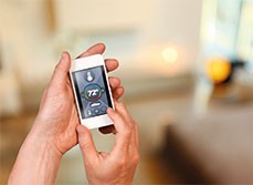 Man using a smartphone to control his home temperature