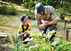 A picture of father and son in green background