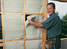 Man installing environmentally friendly home insulation
