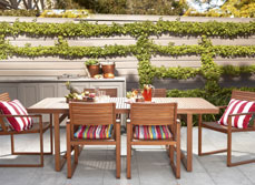 outdoor entertaining area with built in BBQ and wooden table and chairs