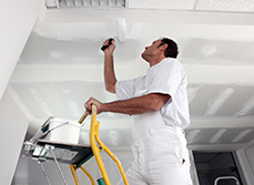 Man reparing a Pinex softboard ceiling