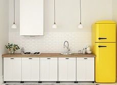 Kitchen with bright yellow fridge and tiles decoration