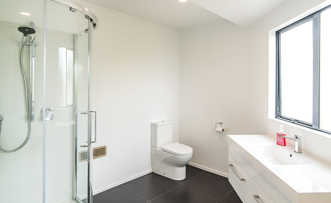 Renovated bathroom with walk-in shower, part of a Refresh Renovations project