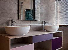 Double sink with purple finished vanity