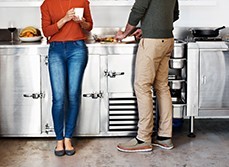 Couple cooking in a steel kitchen